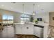 Open-concept kitchen featuring a large island with seating and a view of the backyard and lake at 11233 82Nd E St, Parrish, FL 34219