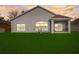 Back of home with a screened-in porch and spacious yard, reflecting warm sunlight and offering outdoor living space at 11233 82Nd E St, Parrish, FL 34219