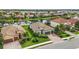 Aerial view of home with well-manicured lawn near lake and other houses at 13112 Ramblewood Trail, Bradenton, FL 34211