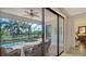 Screened lanai featuring a pool, spa, seating, and a view of the water at 13112 Ramblewood Trail, Bradenton, FL 34211