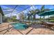 Screened pool and spa area boasts brick pavers and view of the adjacent waterway at 13112 Ramblewood Trail, Bradenton, FL 34211