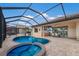Relax in the gorgeous screened-in pool and spa with outdoor kitchen and dining space at 14326 Flat Woods Ter, Lakewood Ranch, FL 34211