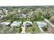 An aerial view of the property shows the home surrounded by mature trees and green lawns at 1604 Edna Ave, Largo, FL 33770