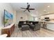 Open-concept living room featuring modern gray sofa, wood floors and view to the bright kitchen at 16117 59Th E Ct, Parrish, FL 34219