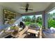Cozy covered patio with brick flooring, ceiling fan, outdoor furniture, and backyard view at 16117 59Th E Ct, Parrish, FL 34219