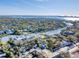 Stunning aerial view of the property nestled on a waterway amid lush landscapes and residential areas at 1762 Bay St # 401, Sarasota, FL 34236