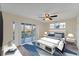 Bright bedroom featuring a ceiling fan, slider doors to deck, and stylish décor at 1762 Bay St # 401, Sarasota, FL 34236