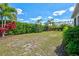 The expansive backyard is surrounded by lush greenery, providing privacy at 2720 Butterfly Jasmine Trl, Sarasota, FL 34240