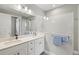 Modern bathroom featuring a double sink vanity and a shower with a glass partition at 2720 Butterfly Jasmine Trl, Sarasota, FL 34240