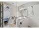 Contemporary bathroom with a walk-in shower, double vanity, and neutral color palette at 2720 Butterfly Jasmine Trl, Sarasota, FL 34240