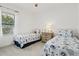 Twin bedroom with two beds, a ceiling fan, and neutral walls at 2720 Butterfly Jasmine Trl, Sarasota, FL 34240