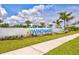 An inviting community entrance sign set against a bright blue sky and lush greenery at 2720 Butterfly Jasmine Trl, Sarasota, FL 34240