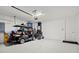 Spacious garage with a golf cart and ample storage space at 2720 Butterfly Jasmine Trl, Sarasota, FL 34240