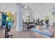 Well-equipped fitness center featuring cardio machines, weights, and ample space for a complete workout routine at 2720 Butterfly Jasmine Trl, Sarasota, FL 34240
