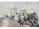 Spacious gym with modern exercise equipment, including cardio machines and free weights for a comprehensive fitness experience at 2720 Butterfly Jasmine Trl, Sarasota, FL 34240