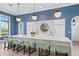 Community kitchenette area featuring a large island with barstool seating and elegant pendant lights for a modern touch at 2720 Butterfly Jasmine Trl, Sarasota, FL 34240