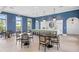 Community kitchenette area boasts a large island with barstool seating and stylish pendant lighting for a modern touch at 2720 Butterfly Jasmine Trl, Sarasota, FL 34240