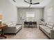 Inviting office space with two couches, desk, and wood-look tile flooring at 2720 Butterfly Jasmine Trl, Sarasota, FL 34240