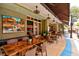 Inviting outdoor seating area with comfortable chairs and tables, perfect for enjoying a meal and ambiance at 2720 Butterfly Jasmine Trl, Sarasota, FL 34240