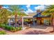 Outdoor seating area with a covered patio and brick flooring at 2720 Butterfly Jasmine Trl, Sarasota, FL 34240