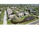 An aerial view shows a community with lush landscaping, a pond with a fountain, and well-maintained buildings at 2832 74Th W St # 2180, Bradenton, FL 34209