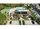 An aerial view showcasing a community pool, spa, and clubhouse with lush landscaping at 2832 74Th W St # 2180, Bradenton, FL 34209