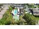 An aerial view showcases a pool and shuffleboard court alongside a clubhouse with ample parking at 2832 74Th W St # 2180, Bradenton, FL 34209