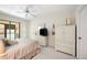 Well-lit bedroom with a television, closet, and access to a balcony with outdoor views at 2832 74Th W St # 2180, Bradenton, FL 34209