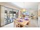 Sunlit dining room with sliding glass doors to lanai, seating for six, and stylish lighting at 2832 74Th W St # 2180, Bradenton, FL 34209