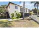Exterior shot of building, showing stairs, second story balcony, landscaping, and a white picket fence at 2832 74Th W St # 2180, Bradenton, FL 34209