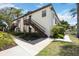 The building features a private entrance with wood stairs, complemented by lush greenery at 2832 74Th W St # 2180, Bradenton, FL 34209