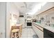 Functional kitchen with white cabinets and appliances and breakfast bar seating at 2832 74Th W St # 2180, Bradenton, FL 34209