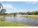 Scenic view of a pond with a fountain and traffic passing by in the distance at 2832 74Th W St # 2180, Bradenton, FL 34209