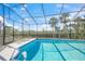 Screened pool area with pristine water, lounge chairs and palm tree views overlooking a waterway at 3421 Bayou Sound, Longboat Key, FL 34228