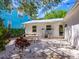 Backyard patio area with a white metal roof, a grill, and outdoor seating at 3629 Almeria Ave, Sarasota, FL 34239
