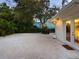 Charming backyard with white gravel, string lights, and lush greenery, perfect for outdoor relaxation at 3629 Almeria Ave, Sarasota, FL 34239