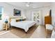 Bright bedroom featuring stylish decor, a cozy bed, and French doors that open to the backyard at 3629 Almeria Ave, Sarasota, FL 34239