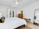 Bright bedroom featuring a ceiling fan, neutral walls, and private access to the outdoors at 3629 Almeria Ave, Sarasota, FL 34239