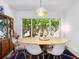 Bright dining room featuring modern pendant lighting and a lush, green backyard view at 3629 Almeria Ave, Sarasota, FL 34239