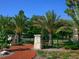 Inviting entrance with brick pathway and stone pillars surrounded by lush landscaping at 3629 Almeria Ave, Sarasota, FL 34239