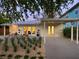 Charming single-story home boasts a well-manicured front yard, covered parking and a cozy outdoor seating area at 3629 Almeria Ave, Sarasota, FL 34239