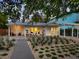 Charming single-story home boasts a well-manicured front yard, covered parking and a cozy outdoor seating area at 3629 Almeria Ave, Sarasota, FL 34239