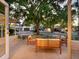 Inviting single-story home with outdoor seating area and a large, mature shade tree in the front yard at 3629 Almeria Ave, Sarasota, FL 34239