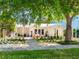 Inviting exterior featuring a covered porch, white facade, and beautifully landscaped front yard at 3629 Almeria Ave, Sarasota, FL 34239