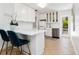 Bright kitchen boasting white cabinets, stainless steel appliances, and an inviting breakfast bar at 3629 Almeria Ave, Sarasota, FL 34239