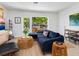 Cozy living room with comfortable sofa, natural light, and views of the outdoor greenery at 3629 Almeria Ave, Sarasota, FL 34239