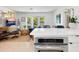 Bright living room showcasing a kitchen bar, stylish decor, and seamless flow to the outside at 3629 Almeria Ave, Sarasota, FL 34239