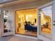 Bright and airy living room view through glass doors, featuring modern furnishings and tile flooring at 3629 Almeria Ave, Sarasota, FL 34239