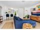 Bright living room featuring a blue sofa, woven accents, and seamless flow to the kitchen at 3629 Almeria Ave, Sarasota, FL 34239