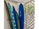 Surfboards mounted on a white wall adjacent to latticework at 3629 Almeria Ave, Sarasota, FL 34239